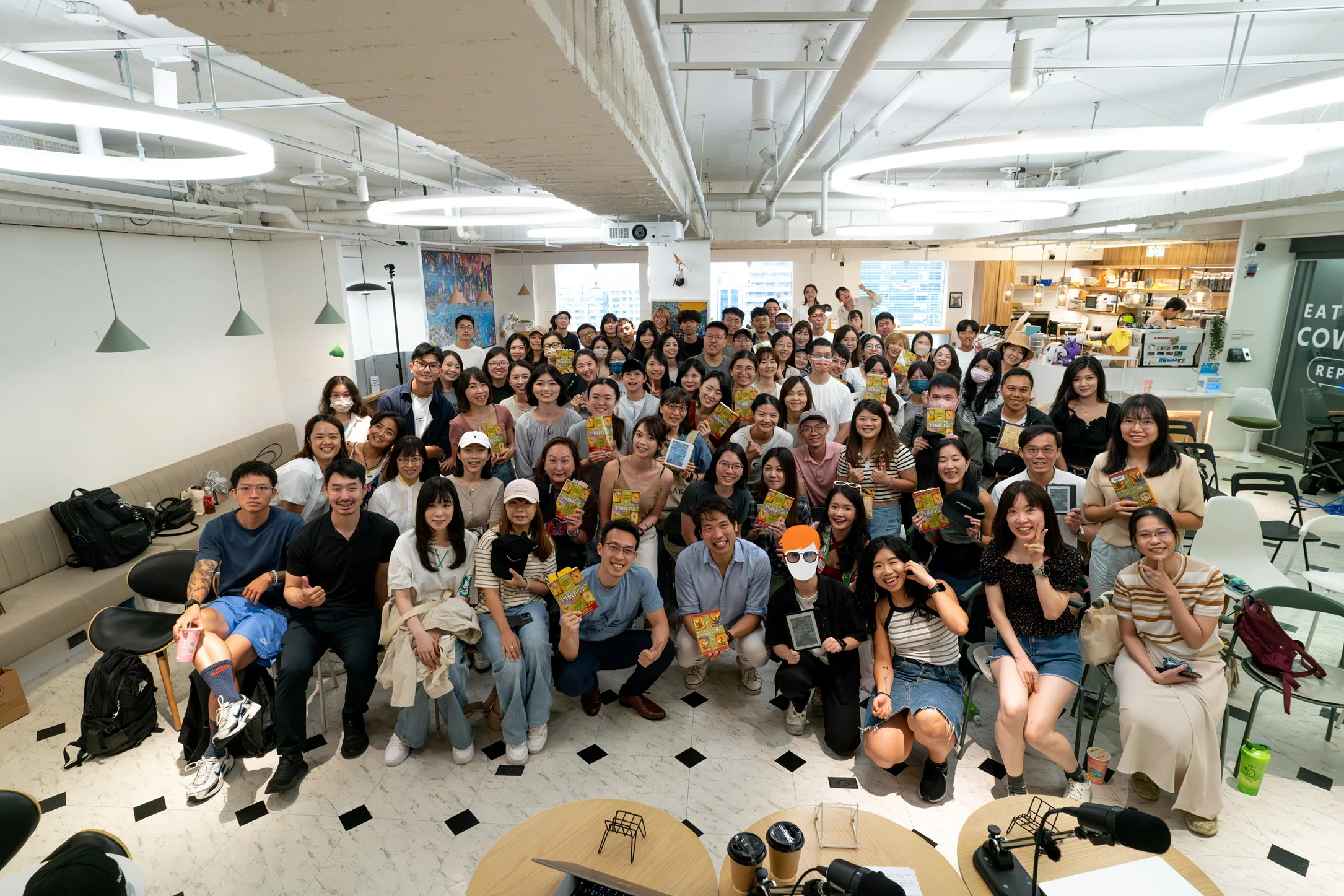 Group photo of book club members holding their books